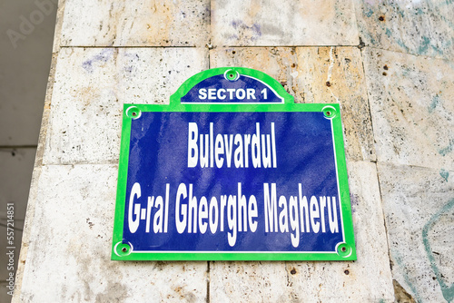 Beautiful vintage street sign showing Bulevardul General Gheorghe Magheru (Gheorghe Magheru Boulevard) displayed on an street in the old city center of Bucharest, Romania, in a sunny day photo