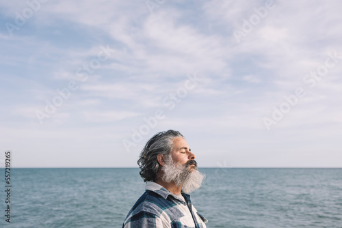 Side view portrait of a bearded man breathing fresh air © jcalvera