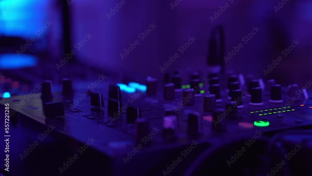 Close up shot of dj mixer controller on disco party, blinking desk with lots of buttons and sliders for mixing sound music, nightclub entertainment, celebration party with dj music Close up shot of dj mixer controller on disco party, blinking desk with lots of buttons and sliders for mixing sound music, nightclub entertainment, celebration party with dj music