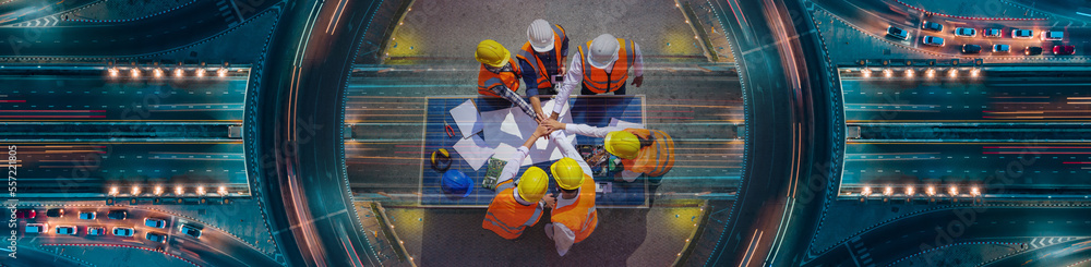 custom made wallpaper toronto digitalTop view of Architectural engineers putting their hands together on solar panel and his blueprints with Solar photovoltaic equipment on construction site. meeting, discussing, designing, planing