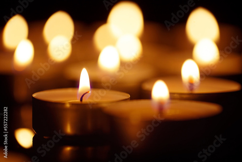 Burning candles on black background  shot with shallow depth of field