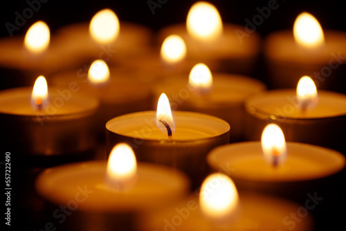 Burning candles on black background, shot with shallow depth of field