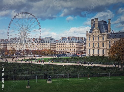 Cityscape view to the Grande Roue de Paris ferris wheel next to Louvre museum building and parisian houses, France photo