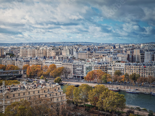 Paris cityscape over the Seine river, view from the Eiffel tower height, France. Fall season scene with colorful yellow trees