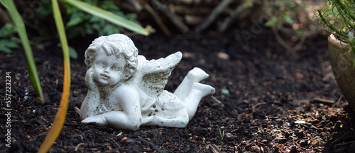 Canvas Print Small angel figure lying on the floor with a small focus plane
