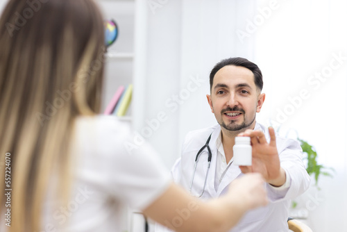 Photo of doctor wearing lab coat giving an ultrasound result to his patient.