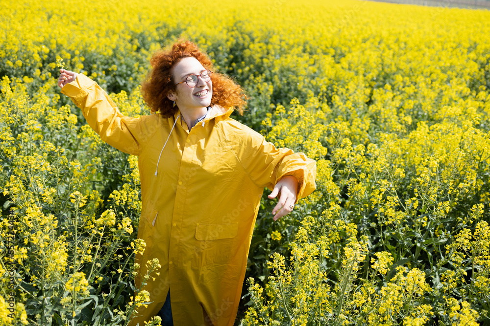 Fototapeta premium A woman dancing and singing in a field of flowers