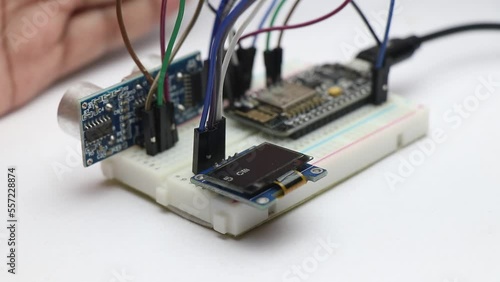 Creative Microcontroller project made from programmable development board that shows the distance on OLED as the hand moves making it a ruler