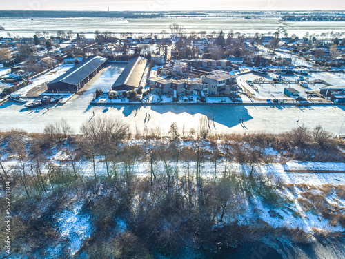 A drone image of the Frisian city of Langweer in winter with snow. photo