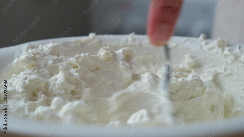 the process of cooking tiramisu. chef cooks homemade mascarpone. whipped cream is mixed with cottage cheese the process of cooking tiramisu. chef cooks homemade mascarpone. whipped cream is mixed with cottage cheese