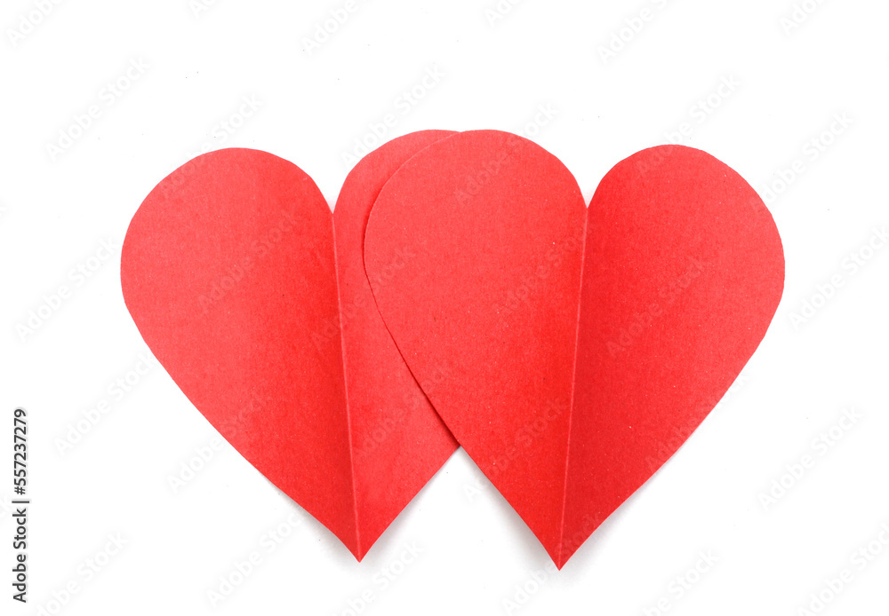 two love cutting red paper hearts on white