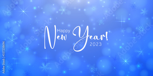 Happy New Year 2023. Holiday greeting card design. White paper numbers on a defocused colorful, bokeh background.