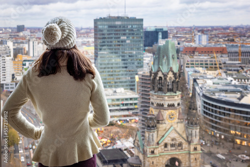 Photography A tourist woman in white winter clothes enjoys the panoramic view over the skyli