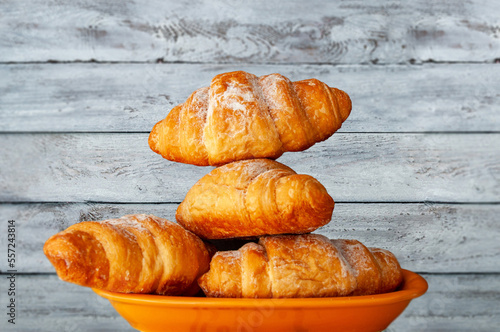 croissant on table, white wood background