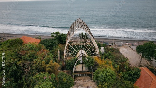 Abandoned dilapidated building in front of the beach. Taman Festival Padang Galak in Bali, Indonesia. drone image