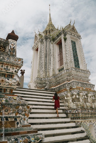 vertical tourist girl at wat arun temple in bangkok, thailand