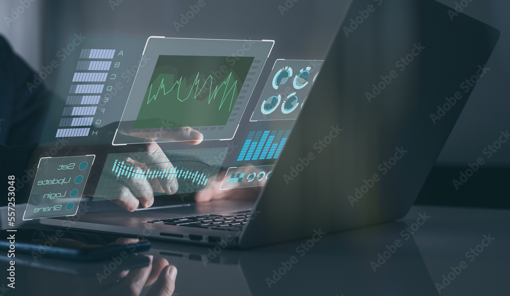 Graphs and charts on virtual computer screen. Businessman works statistical data on laptop in office Graphs and charts on virtual computer screen. Businessman works statistical data on laptop in office