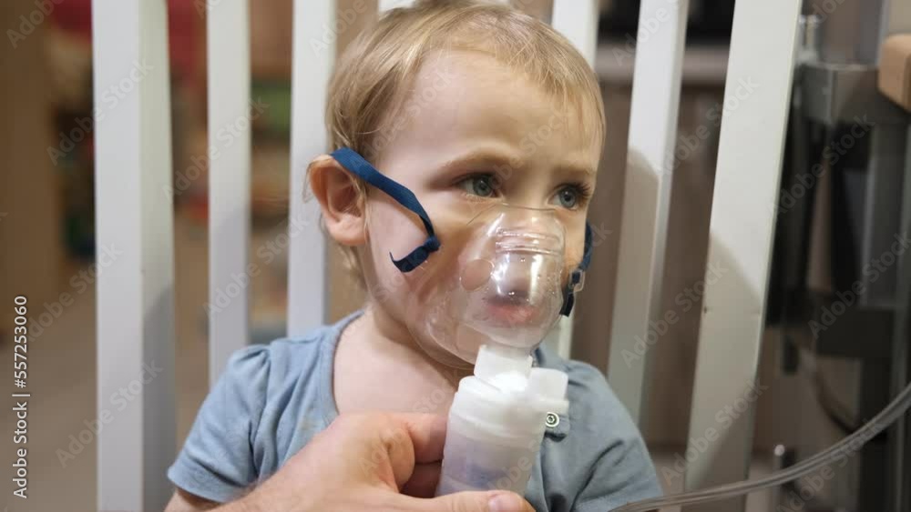 Sick Baby Girl with making Inhalation with a Mask on his Face sitting
