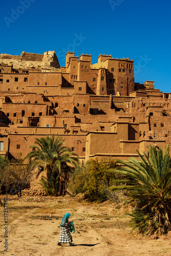 North Africa. Morocco. A woman walking in front of the village of Ait Benhaddou