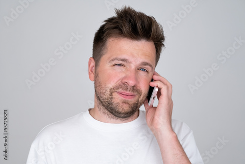 Young caucasian man talking speaking by mobile cell phone. 