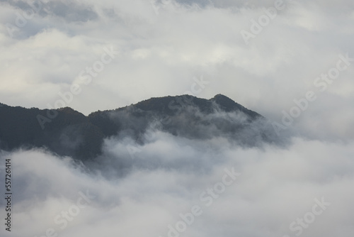 Stunning view of a high hill jutting out of the clouds on the volcanic island of Madeira in the Atlantic Ocean.