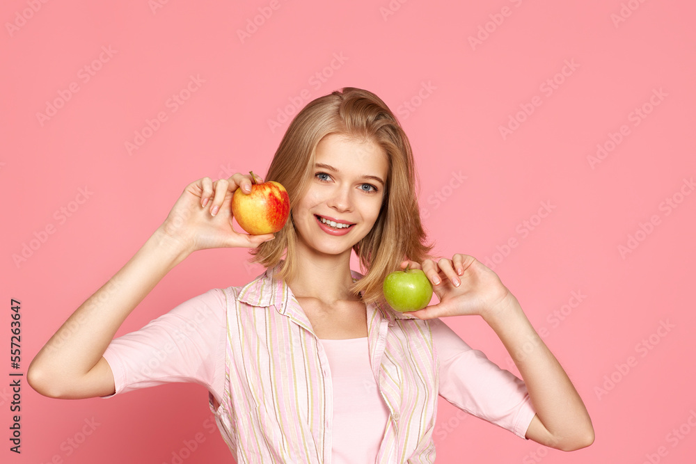 smiling woman holding green and yellow apples smiling woman holding green and yellow apples