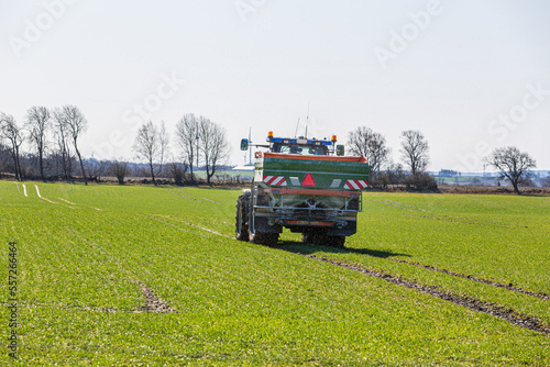 Tractor in field spreading manure