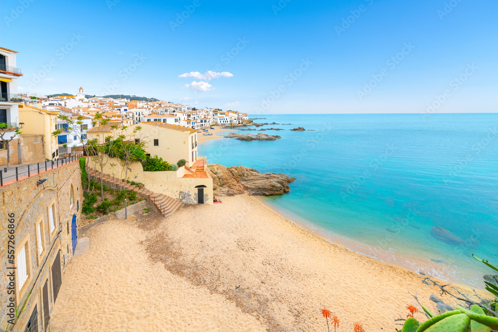 The rocky coast, sandy beach and whitewashed village at the fishing town of Calella de Palafrugell, on the Costa Brava Spanish coast.
