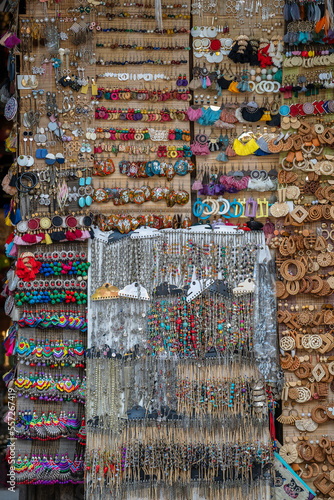 Colorful handmade earrings for sale for tourists at the street market in Hoi An old town, Vietnam, closeup