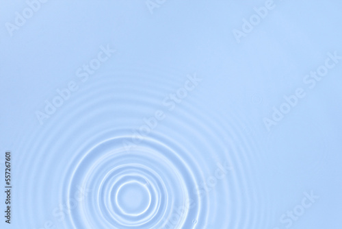 Blue water background with the surface of the blobs of water from the drop, top view