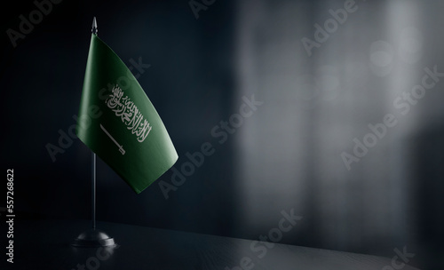 Small national flag of the Saudi Arabia on a black background
