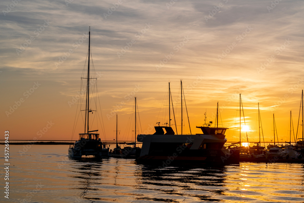 Beautiful colourful sunset at Olhao, Portugal with boat silhouettes