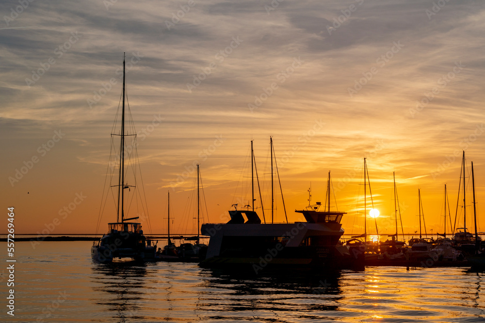 Beautiful colourful sunset at Olhao, Portugal with boat silhouettes