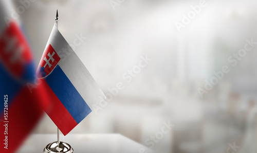 Small flags of the Slovakia on an abstract blurry background photo