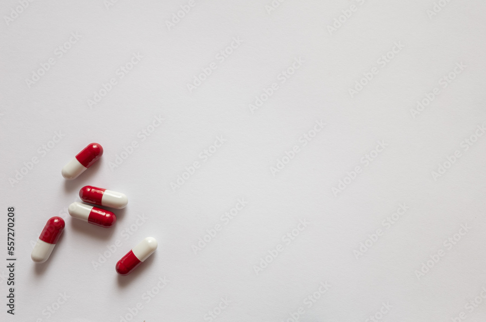 Pills red-white capsules on a white background with a copy space. Pills red-white capsules on a white background with a copy space.