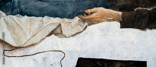 Obraz na plátně A young man with curly hair holds a handkerchief in his hand