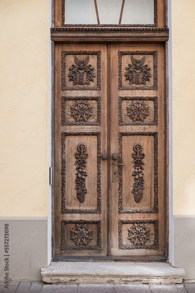 Medieval door with fine wooden symbols and carvings. Beautiful historic wooden door from old town of Tallinn, Estonia.