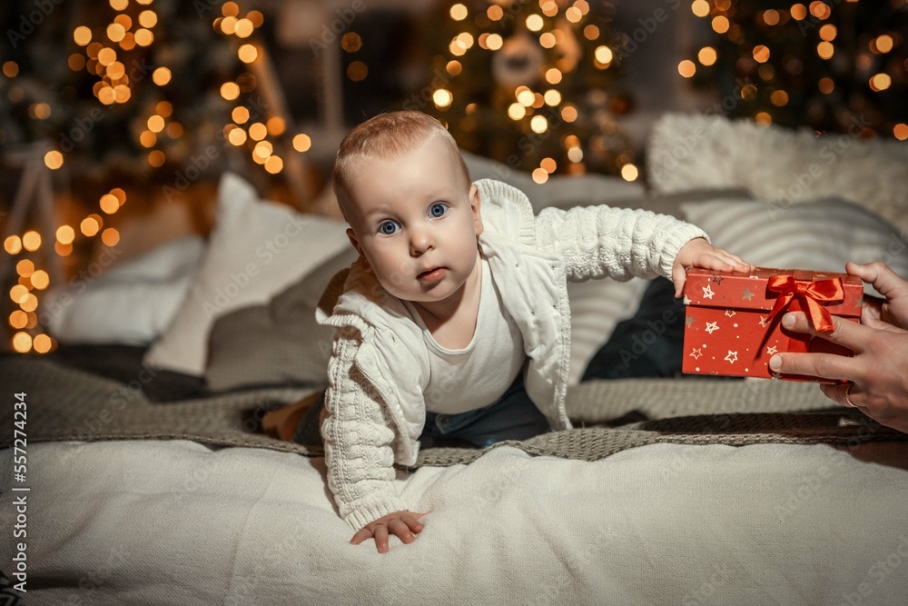 child on the background of a decorated Christmas tree child on the background of a decorated Christmas tree