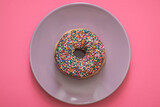 Chocolate Sprinkled Donut on Purple Plate with Pink Background