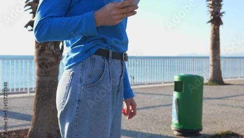 The girl takes her mobile phone out of her pocket and answers the call.