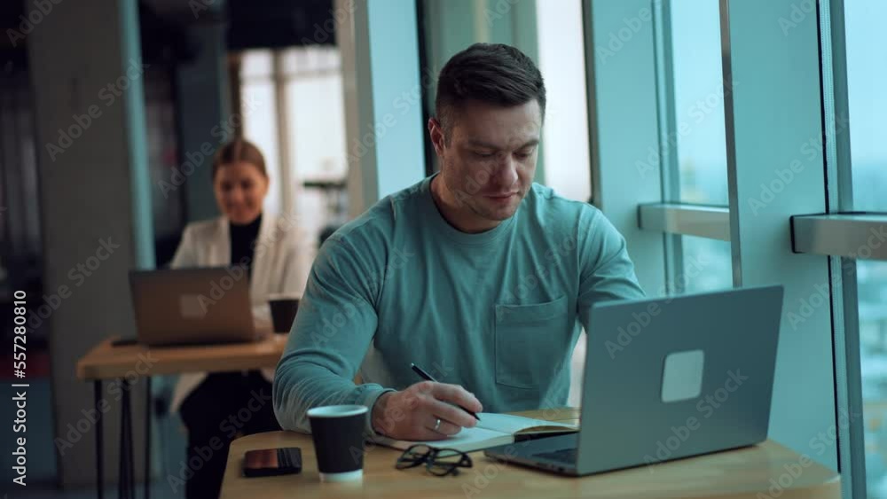Handsome young business manager working with laptop. Smart businessman in cafe working. Handsome young business manager working with laptop. Smart businessman in cafe working.