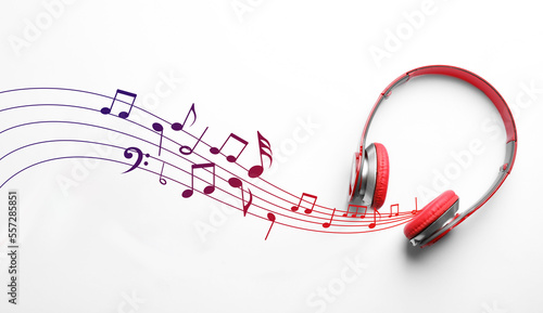 Staff with music notes flowing from red headphones on white background, top view photo