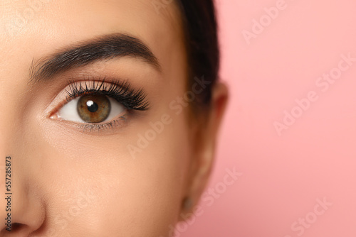 Fototapeta Naklejka Na Ścianę i Meble -  Beautiful young woman with long eyelashes on pink background, closeup. Space for text
