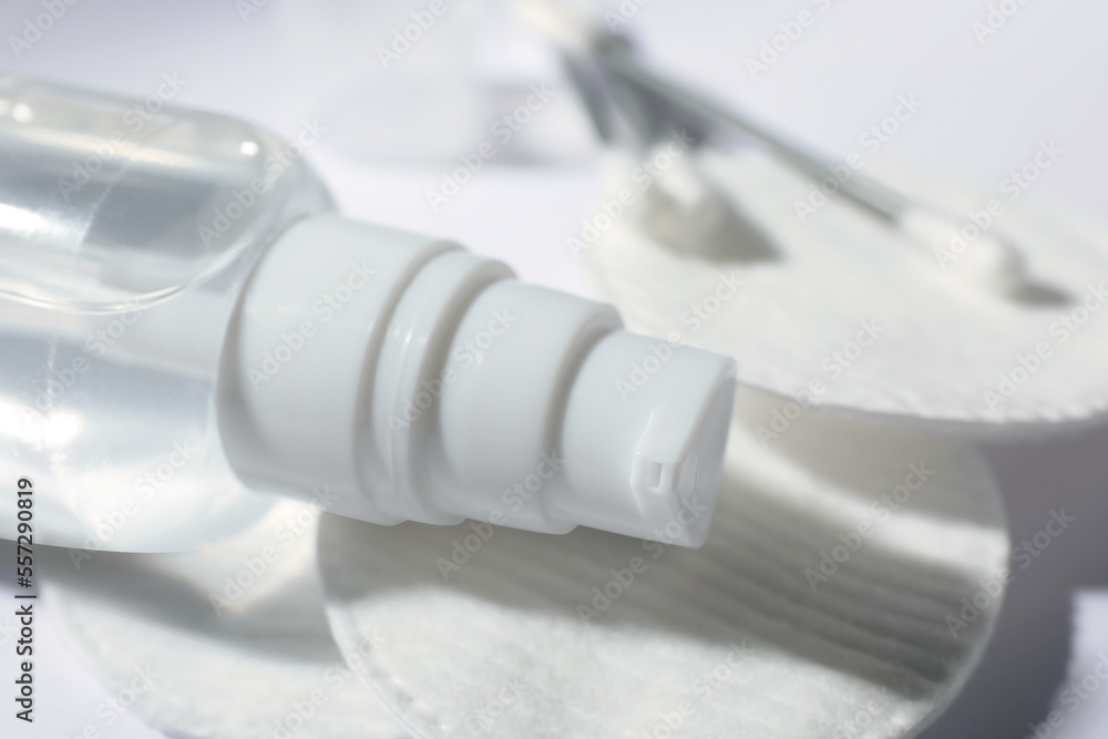 Bottle of micellar water, cotton pads and swabs on white table, closeup Bottle of micellar water, cotton pads and swabs on white table, closeup
