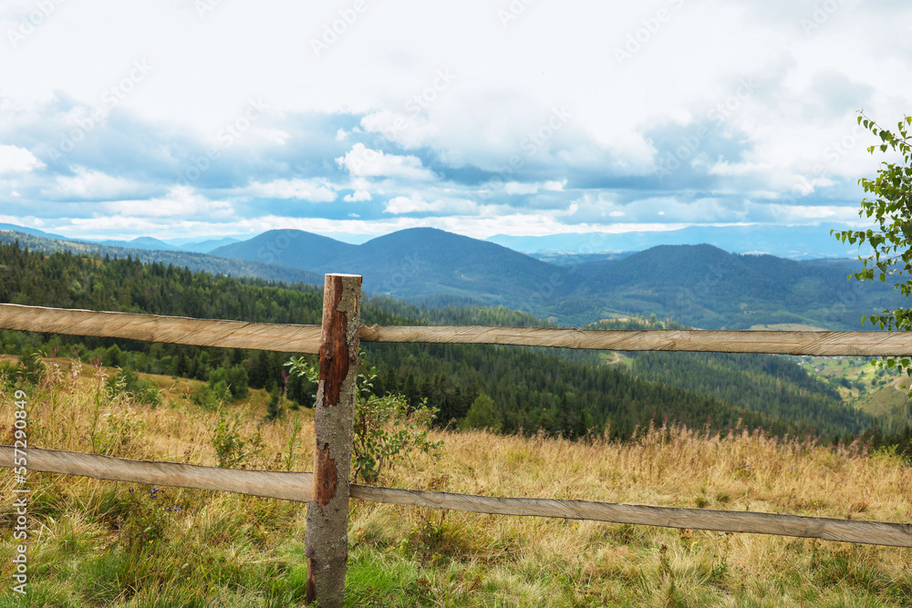 Wooden fence and picturesque view of mountain landscape