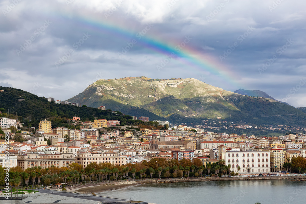 Touristic City by the Sea. Salerno, Italy. Aerial View. Cityscape background with Rainbow over Mountains