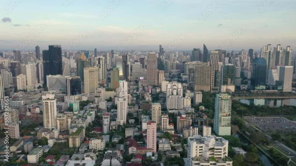 Aerial reveal skyline and skyscrapers of Sukhumvit district, Pathum Wan and Lumphini Park during sunset in Bangkok, Thailand. Aerial reveal skyline and skyscrapers of Sukhumvit district, Pathum Wan and Lumphini Park during sunset in Bangkok, Thailand.