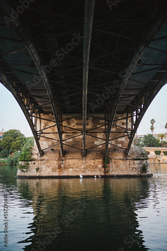 Shot of Triana bridge from below in Seville. Guadalquivir river.