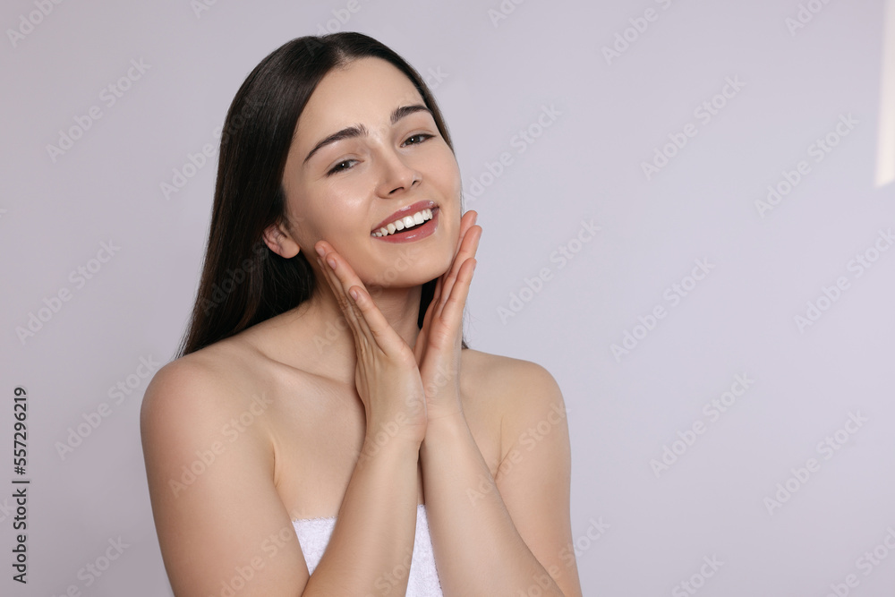 Portrait of attractive young woman on light grey background, space for text. Spa treatment Portrait of attractive young woman on light grey background, space for text. Spa treatment