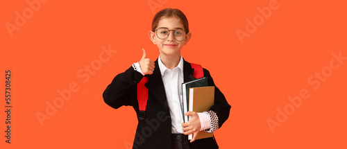 Happy little school girl wi...